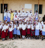 Group photo celebrating menstrual dignity as students receive and hold their reusable pads.