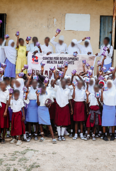 Group photo celebrating menstrual dignity as students receive and hold their reusable pads.