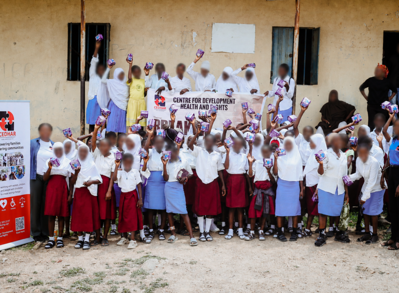 Group photo celebrating menstrual dignity as students receive and hold their reusable pads.