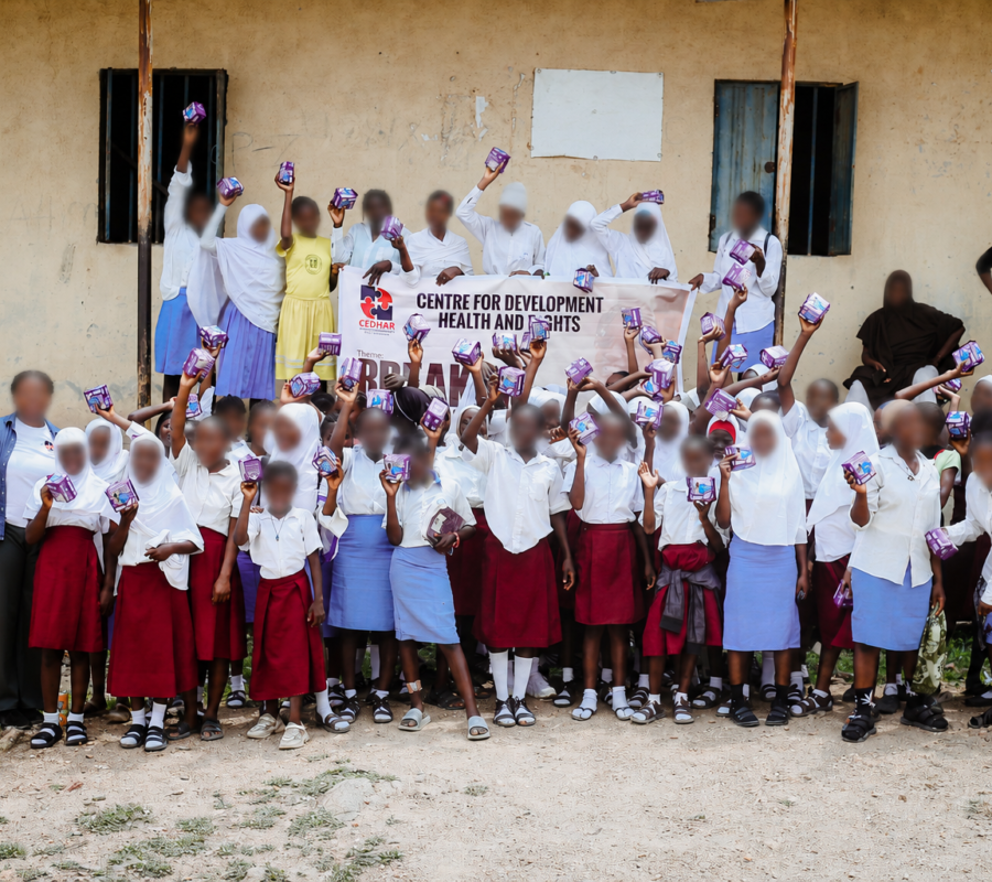 Group photo celebrating menstrual dignity as students receive and hold their reusable pads.